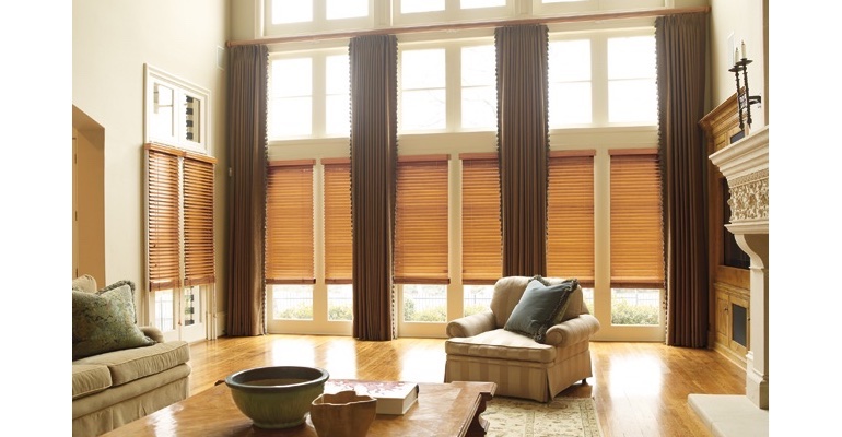 Sacramento great room with wooden blinds and full-length drapes.